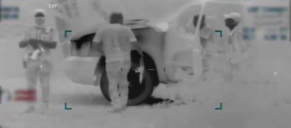 Armed smugglers escort migrant family across US border in Arizona - CBP footage - Sputnik International