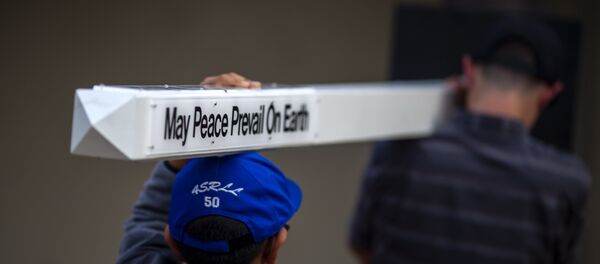 Boys carry a peace pole to an interfaith prayer and candlelight vigil at Rancho Bernardo Community Presbyterian Church on April 27, 2019 in Poway, California. Boys carry a peace pole to an interfaith prayer and candlelight vigil at Rancho Bernardo Community Presbyterian Church on April 27, 2019 in Poway, California. - Sputnik International