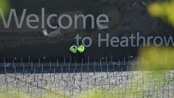 Police officers stand guard near the entrance to Terminal 2 and 3 close to where climate change activists held a demonstration outside Heathrow Airport in west London on April 19, 2019 during the fifth day of an environmental protest by the Extinction Rebellion group. - Sputnik International