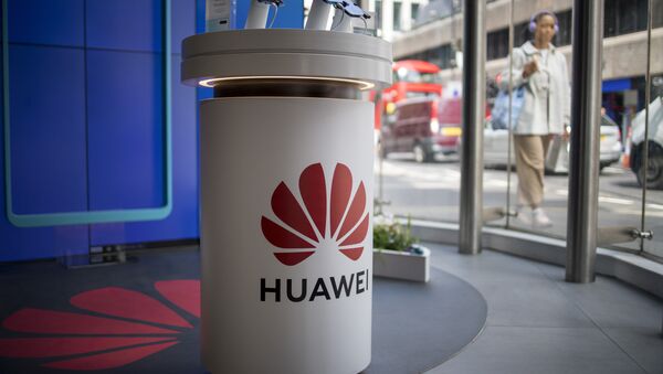 A pedestrian walks past a Huawei product stand at an EE telecommunications shop in central London on April 29, 2019 - Sputnik International