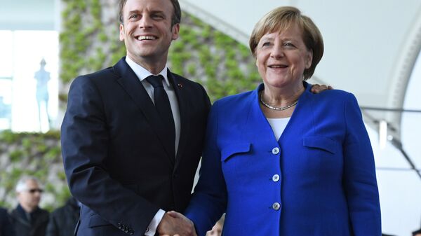 German Chancellor Angela Merkel welcomes French President Emmanuel Macron before a meeting with Western Balkans leaders, at the Chancellery in Berlin, Germany, April 29, 2019. - Sputnik International