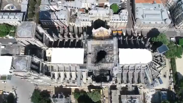 A drone video by Paris Prefecture de Police shows Notre Dame cathedral's roof secured following a massive fire two weeks prior - Sputnik International