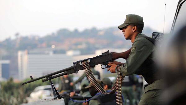 A military member aims a weapon near the Generalisimo Francisco de Miranda Airbase La Carlota, in Caracas, Venezuela April 30, 2019 - Sputnik International