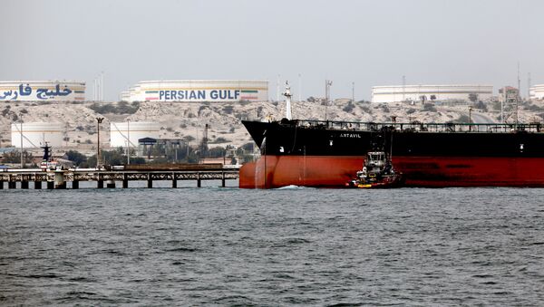A picture taken on March 12, 2017, shows an Iranian tanker docking at the platform of the oil facility in the Khark Island, on the shore of the Gulf - Sputnik International