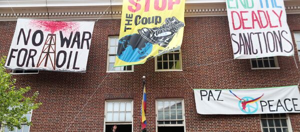 An activist in opposition of the U.S. involvement in Venezuela occupying the Venezuelan Embassy, sits in a window sill in Washington, U.S., April 25, 2019. An activist in opposition of the U.S. involvement in Venezuela occupying the Venezuelan Embassy, sits in a window sill in Washington, U.S., April 25, 2019. - Sputnik International