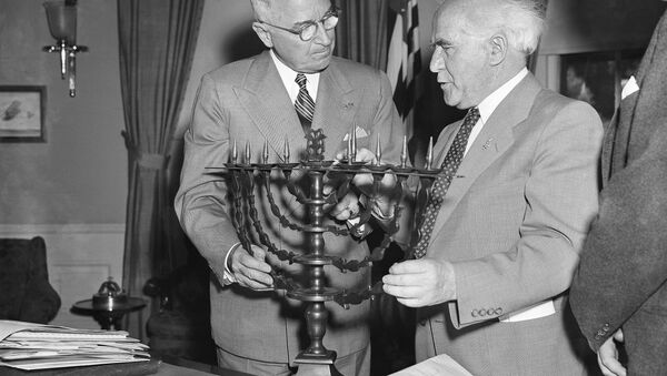 President Harry Truman receives an ornate bronze menorah as a birthday gift from David Ben-Gurion, prime minister of Israel, who called on the chief executive to discuss peace and economic development in the Middle East, May 8, 1951. Ben-Gurion said the menorah was made in 1767. This is the president's 67th birthday - Sputnik International