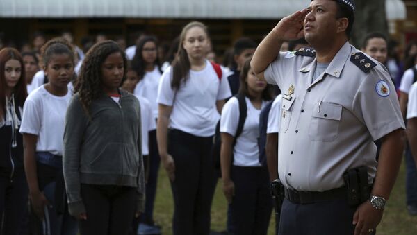 In this March 28, 2019 photo, Major Edney Freire salutes the flag during a ceremony in the main courtyard of the Ceilandia state school No. 7 in Brasilia, Brazil - Sputnik International