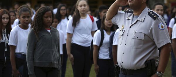 In this March 28, 2019 photo, Major Edney Freire salutes the flag during a ceremony in the main courtyard of the Ceilandia state school No. 7 in Brasilia, Brazil In this March 28, 2019 photo, Major Edney Freire salutes the flag during a ceremony in the main courtyard of the Ceilandia state school No. 7 in Brasilia, Brazil - Sputnik International