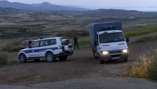 A police truck carries a body found after Cypriot investigators and police officers searched at a field outside of Orounta village - Sputnik International