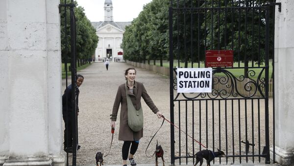A woman brings her dogs to a polling station in London in 2018 - Sputnik International
