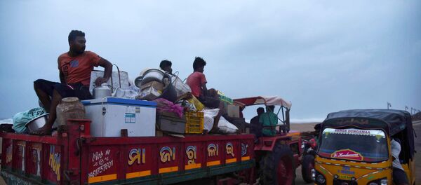 Villagers sit on a vehicle as they leave for a safer place ahead of cylcone Fani on the outskirts of Konark in the eastern state of Odisha, India, May 2, 2019. Villagers sit on a vehicle as they leave for a safer place ahead of cylcone Fani on the outskirts of Konark in the eastern state of Odisha, India, May 2, 2019. - Sputnik International