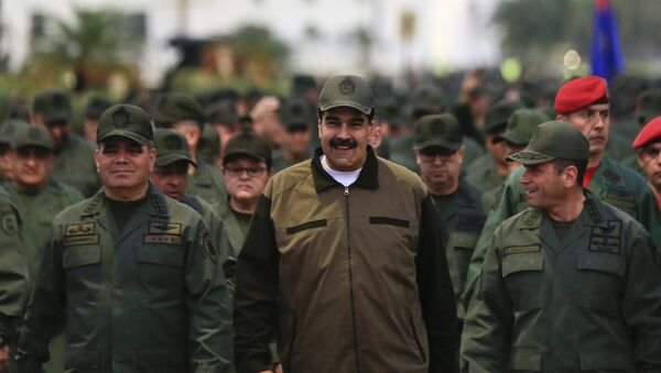 In this handout photo released by Miraflores Press Office, Venezuela's President Nicolas Maduro, center, accompanied by Defense Minister Gen. Vladimir Padrino Lopez, left, and the Strategies Operations Commander, Adm. Remigio Ceballos, arrive for a meeting with the troops at Fort Tiuna in Caracas, Venezuela, Thursday, May 2, 2019 - Sputnik International