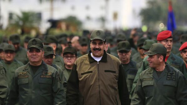 In this handout photo released by Miraflores Press Office, Venezuela's President Nicolas Maduro, center, accompanied by Defense Minister Gen. Vladimir Padrino Lopez, left, and the Strategies Operations Commander, Adm. Remigio Ceballos, arrive for a meeting with the troops at Fort Tiuna in Caracas, Venezuela, Thursday, May 2, 2019 - Sputnik International