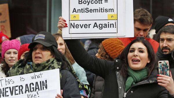 Political activist Laura Loomer, right, holds a sign across the street from a rally organized by Women's March NYC after she barged onto the stage interrupting Women's March NYC director Agunda Okeyo who was speaking during a rally in Lower Manhattan, Saturday, Jan. 19, 2019, in New York. Loomer was escorted off the stage after the incident - Sputnik International