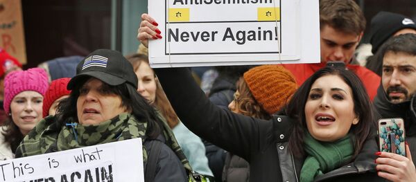 Political activist Laura Loomer, right, holds a sign across the street from a rally organized by Women's March NYC after she barged onto the stage interrupting Women's March NYC director Agunda Okeyo who was speaking during a rally in Lower Manhattan, Saturday, Jan. 19, 2019, in New York. Loomer was escorted off the stage after the incident - Sputnik International