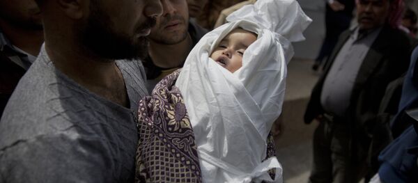 A relative of a Palestinian, 14-month-old, Seba Abu Arar, carry her body out of the Shifa hospital morgue before her funeral in Gaza City, Sunday, May. 5, 2019. Gaza's Health Ministry said the Palestinian infant was killed when Israeli aircraft hit near her house - Sputnik International