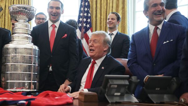 U.S. President Donald Trump shares a moment with left wing and MVP Alexander Ovechkin of the Washington Capitals, defenseman John Carlson, and team owner Ted Leonsis during an Oval Office event at the White House March 25, 2019 in Washington, DC - Sputnik International
