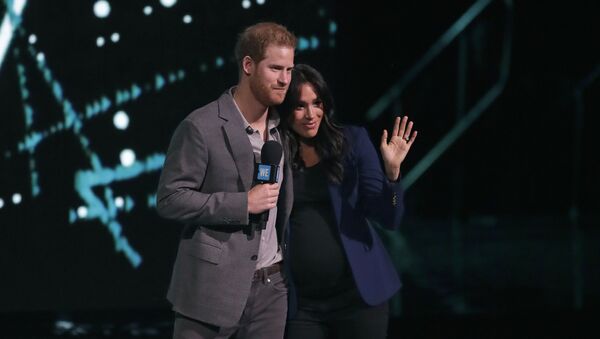 Meghan, the Duchess of Sussex, is brought on stage by Britain's Prince Harry during his speech at WE Day UK, a global initiative to encourage young people to take part in positive social change at the SSE Arena in Wembley, London, Wednesday, March 6, 2019 - Sputnik International