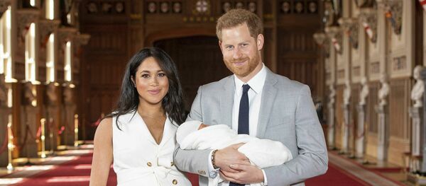 Britain's Prince Harry and Meghan, Duchess of Sussex, during a photocall with their newborn son, in St George's Hall at Windsor Castle, Windsor, south England, Wednesday May 8, 2019 Britain's Prince Harry and Meghan, Duchess of Sussex, during a photocall with their newborn son, in St George's Hall at Windsor Castle, Windsor, south England, Wednesday May 8, 2019 - Sputnik International