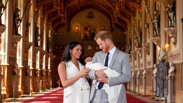 Britain's Prince Harry and Meghan, Duchess of Sussex are seen with their baby son, who was born on Monday morning, during a photocall in St George's Hall at Windsor Castle, in Berkshire, Britain May 8, 2019 - Sputnik International