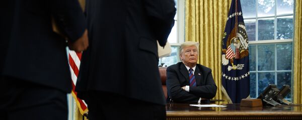 President Trump at his desk by the telephone, file photo. - Sputnik International