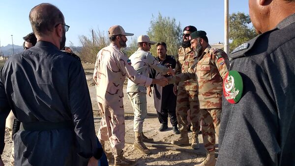 In this picture taken on 21 April 2019, Pakistani border security officials (R) and Iranian border security officials (L) shake hand each others at Zero Point in the Pakistan-Iran border town of Taftan. - Sputnik International