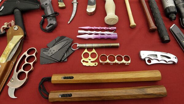 In this 6 April 2017, file photo, objects confiscated from passengers' carry-on luggage, including nunchucks, bottom, are displayed at Seattle-Tacoma International Airport in SeaTac, Wash. - Sputnik International