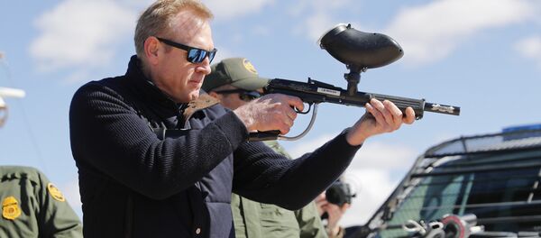 In this Feb. 23, 2019, photo, acting Secretary of Defense Patrick Shanahan, center, fires a modified painted ball gun that shoots pepper balls during a tour of the US-Mexico border at Santa Teresa Station in Sunland Park, N.M., Saturday, Feb. 23, 2019. Shanahan, the former Boeing executive, was in a familiar place, aboard an airplane, when he got word of a bolt-from-the-blue political shot across his bow. A key senator seemed to have buried Shanahan’s chances of being nominated as the next secretary of defense. The crisis passed, but it highlighted the precarious position Shanahan occupies as he waits for President Donald Trump to decide who he will successor to Jim Mattis as leader of the Pentagon. (AP Photo/Pablo Martinez Monsivais) In this Feb. 23, 2019, photo, acting Secretary of Defense Patrick Shanahan, center, fires a modified painted ball gun that shoots pepper balls during a tour of the US-Mexico border at Santa Teresa Station in Sunland Park, N.M., Saturday, Feb. 23, 2019. Shanahan, the former Boeing executive, was in a familiar place, aboard an airplane, when he got word of a bolt-from-the-blue political shot across his bow. A key senator seemed to have buried Shanahan’s chances of being nominated as the next secretary of defense. The crisis passed, but it highlighted the precarious position Shanahan occupies as he waits for President Donald Trump to decide who he will successor to Jim Mattis as leader of the Pentagon. (AP Photo/Pablo Martinez Monsivais) - Sputnik International