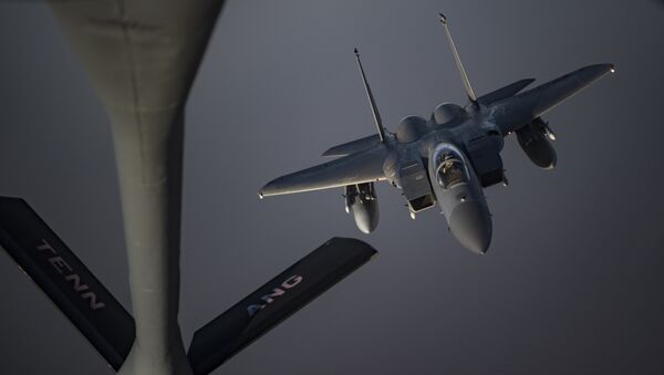 An Airman piloting an F-15C Eagle prepares to receive fuel from a KC-135 Stratotanker from the 28th Expeditionary Aerial Refueling Squadron, May 12, 2019, at an undisclosed location. The 28th EARS maintains constant presence in the U.S. Air Forces Central Command area of responsibility, supporting U.S. and Coalition aircraft in various operations conducted in Iraq, Syria, and Afghanistan. - Sputnik International