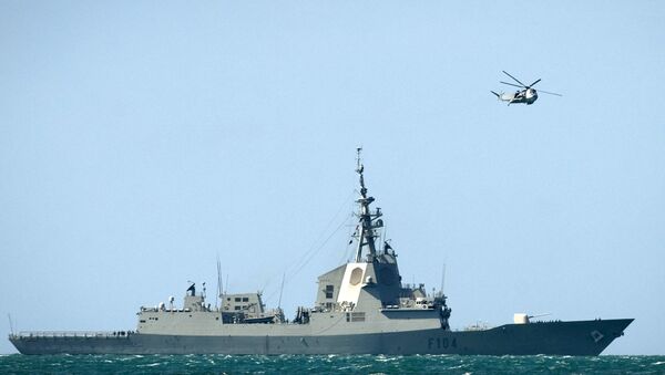 A helicopter flies over Spanish frigate Mendez Nunez as she arrives to the Naval Base of Rota near Cadiz on March 22, 2011. Two Spanish F-18 fighter jets staged their first sorties over Libya yesterday to enforce a UN-mandated no-fly zone, the defence ministry said. An F-100 frigate, an S-74 submarine and a CN-235 maritime surveillance plane will also be deployed by Spain to help enforce an arms embargo on Libya. - Sputnik International