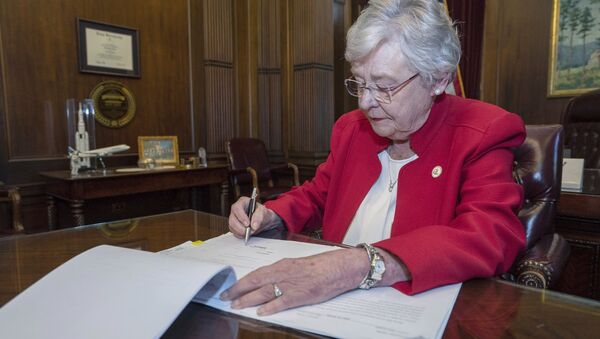 This photograph released by the state shows Alabama Gov. Kay Ivey signing a bill that virtually outlaws abortion in the state on Wednesday, May 15, 2019, in Montgomery, Ala. - Sputnik International