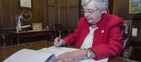 This photograph released by the state shows Alabama Gov. Kay Ivey signing a bill that virtually outlaws abortion in the state on Wednesday, May 15, 2019, in Montgomery, Ala. This photograph released by the state shows Alabama Gov. Kay Ivey signing a bill that virtually outlaws abortion in the state on Wednesday, May 15, 2019, in Montgomery, Ala. - Sputnik International