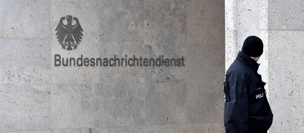 A policeman stands guard next to the logo and name of the German Federal Intelligence Service (BND) A policeman stands guard next to the logo and name of the German Federal Intelligence Service (BND) - Sputnik International