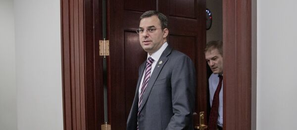 File-This March 28, 2017, file photo shows Rep. Justin Amash, R-Mich., followed by Rep. Jim Jordan, R-Ohio, leaving a closed-door strategy session with Speaker of the House Paul Ryan, R-Wis. A top aide to President Donald Trump is urging the primary defeat of a conservative House member from Michigan. A tweet Saturday, April 1, 2017, by White House social media director Dan Scavino Jr., comes two days after Trump threatened conservative lawmakers who thwarted a House vote on health care legislation. Scavino targeted Amash, a member of the conservative Freedom Caucus criticized by Trump. File-This March 28, 2017, file photo shows Rep. Justin Amash, R-Mich., followed by Rep. Jim Jordan, R-Ohio, leaving a closed-door strategy session with Speaker of the House Paul Ryan, R-Wis. A top aide to President Donald Trump is urging the primary defeat of a conservative House member from Michigan. A tweet Saturday, April 1, 2017, by White House social media director Dan Scavino Jr., comes two days after Trump threatened conservative lawmakers who thwarted a House vote on health care legislation. Scavino targeted Amash, a member of the conservative Freedom Caucus criticized by Trump. - Sputnik International