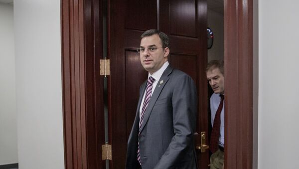 File-This March 28, 2017, file photo shows Rep. Justin Amash, R-Mich., followed by Rep. Jim Jordan, R-Ohio, leaving a closed-door strategy session with Speaker of the House Paul Ryan, R-Wis. A top aide to President Donald Trump is urging the primary defeat of a conservative House member from Michigan. A tweet Saturday, April 1, 2017, by White House social media director Dan Scavino Jr., comes two days after Trump threatened conservative lawmakers who thwarted a House vote on health care legislation. Scavino targeted Amash, a member of the conservative Freedom Caucus criticized by Trump. - Sputnik International