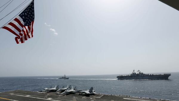 In this Friday, May 17, 2019, photo, released by the U.S. Navy, the amphibious assault ship USS Kearsarge, right, and the Arleigh Burke-class guided-missile destroyer USS Bainbridge, left, are seen from the Nimitz-class aircraft carrier USS Abraham Lincoln as they sail in the Arabian Sea - Sputnik International