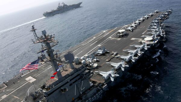 The Nimitz-class aircraft carrier USS Abraham Lincoln (CVN 72) and the Wasp-class Amphibious Assault Ship USS Kearsarge (LHD 3) sail alongside, as the Abraham Lincoln Carrier Strike Group (ABECSG) and Kearsarge Amphibious Ready Group (KSGARG) conduct joint operations, in the U.S. 5th Fleet area of operations in the Arabian Sea, May 17, 2019 - Sputnik International