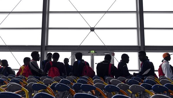 Asylum seekers who have been rescued by the Aquarius rescue ship and another ship in the Mediterranean sea, wait upon their arrival at Roissy-Charles de Gaulle airport, in Roissy-en-France, north of Paris, on August 30, 2018 - Sputnik International
