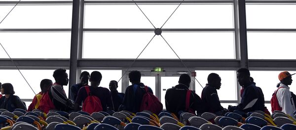 Asylum seekers who have been rescued by the Aquarius rescue ship and another ship in the Mediterranean sea, wait upon their arrival at Roissy-Charles de Gaulle airport, in Roissy-en-France, north of Paris, on August 30, 2018 - Sputnik International