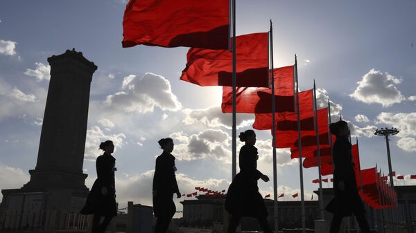 Bus ushers walk past red flags on Tiananmen Square during a plenary session of the Chinese People's Political Consultative Conference (CPPCC) at the Great Hall of the People in Beijing Monday, March 11, 2019 - Sputnik International
