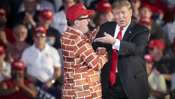 U.S. President Donald Trump calls up Blake Marnell, wearing a jacket with bricks representing a border wall, to the stage during a 'Make America Great Again' campaign rally at Williamsport Regional Airport, May 20, 2019 in Montoursville, Pennsylvania - Sputnik International