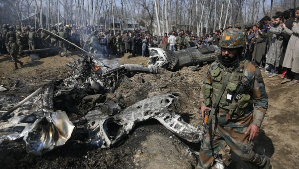 An Indian army soldier walks past the wreckage of an Indian helicopter after it crashed in Budgam area, outskirts of Srinagar, Indian controlled Kashmir, Wednesday, Feb.27, 2019 - Sputnik International