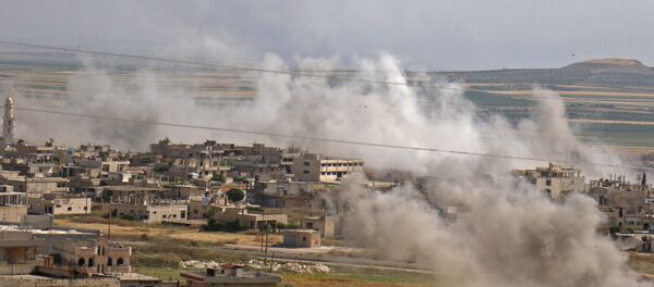 This picture taken on May 22, 2019 shows smoke plumes rising from the Syrian town of Khan Sheikhun in the southern countryside of the rebel-held Idlib province. - Sputnik International