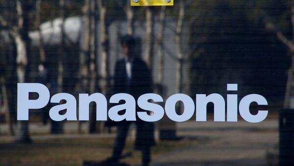 A man is reflected on Panasonic Corp's logo at Panasonic Center in Tokyo - Sputnik International