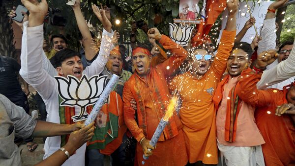 Bharatiya Janata Party (BJP) workers celebrate outside BJP headquarters in New Delhi India, Thursday, May 23, 2019 - Sputnik International