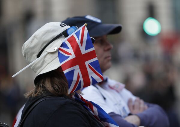 A protester wears a British union flag as people gather near parliament during Brexit demonstrations in London, Friday March 29, 2019. - Sputnik International