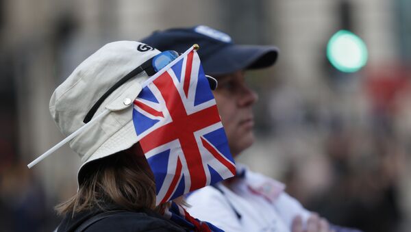 A protester wears a British union flag as people gather near parliament during Brexit demonstrations in London, Friday March 29, 2019. - Sputnik International