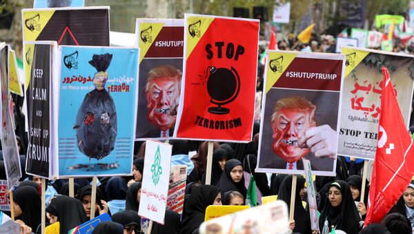 Iranian women carrying placards, some bearing the portrait of US President Donald Trump, during a demonstration outside the former US embassy in the Iranian capital Tehran on November 4, 2017, marking the anniversary of its storming by student protesters that triggered a hostage crisis in 1979 - Sputnik International