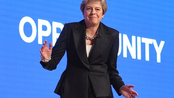 Britain's Prime Minister Theresa May dances a few steps as she takes the stage to give her keynote address on the fourth and final day of the Conservative Party Conference 2018 at the International Convention Centre in Birmingham, central England, on October 3, 2018 - Sputnik International
