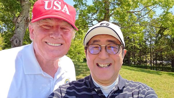 This handout photo taken from the twitter account of The Prime Minister's Office of Japan on May 26, 2019 shows US President Donald Trump (L) and Japan's Prime Minister Shinzo Abe (R) posing for a photograph while playing a round of golf at Mobara Country Club in Chiba.  Handout / The Prime Minister's Office of Japan - Sputnik International